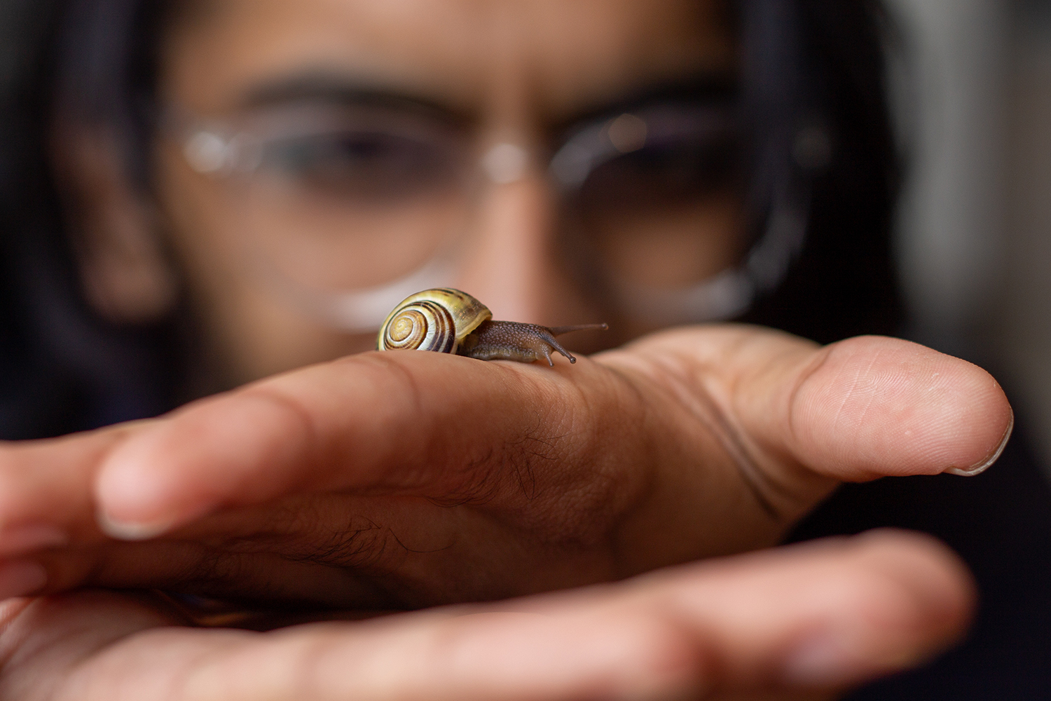 A friend with a snail in hand